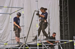 riggers working on attaching lighting and audio equipment