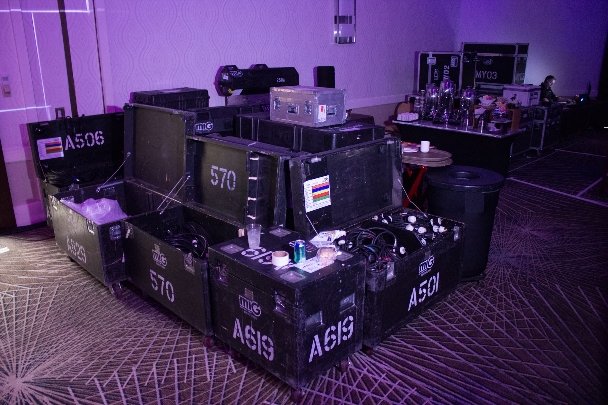 a grouping of empty dead cases being stored together backstage at a live event