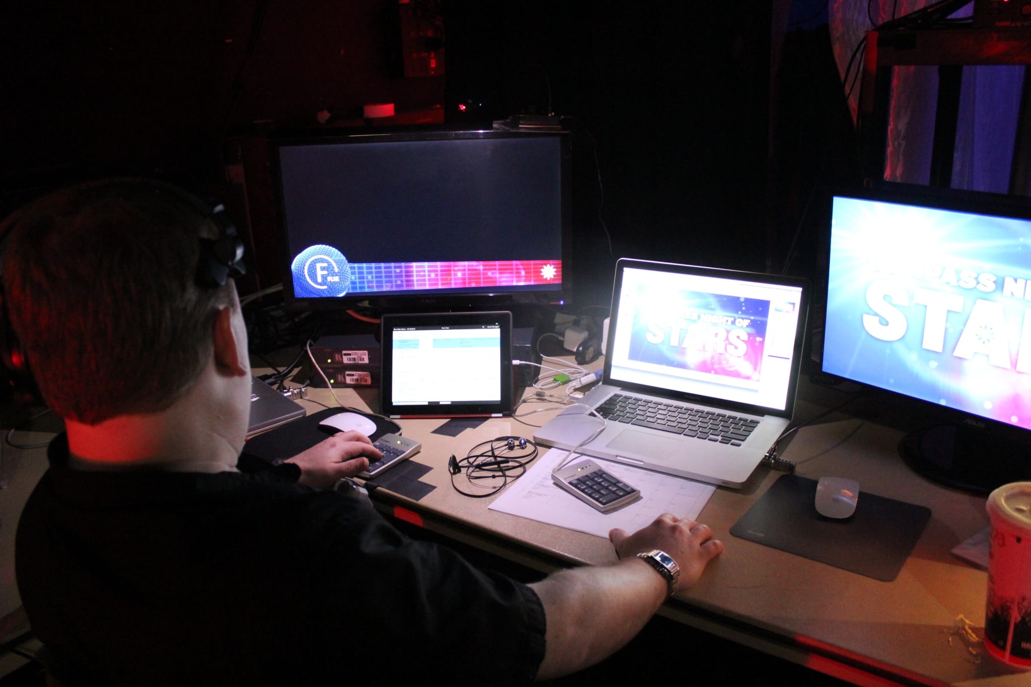 a technician using a laptop to coordinate the image on screen